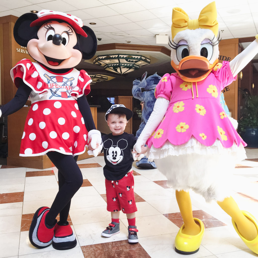 Landon with Minnie Mouse and Daisy Duck who welcomed us in the lobby of the Paradise Pier Hotel for our Disneyland trip in September 2018. Disneyland vacation planning tips and tricks from a Disney Pro. Brianna K Bitsofbri bits of bri Cleveland mom blog Disneyland planning advice where to stay what to eat what age to go to disney 