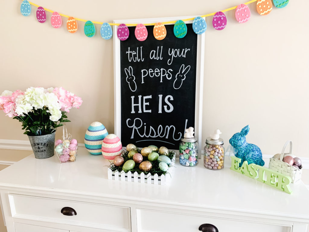 easter chalkboard and easter decorations on white buffet table  Brianna K bits of bri bitsofbri easter decor hour tour 2019 spring and easter decorations around her home flowers bunnies dollar tree DIY decorations 