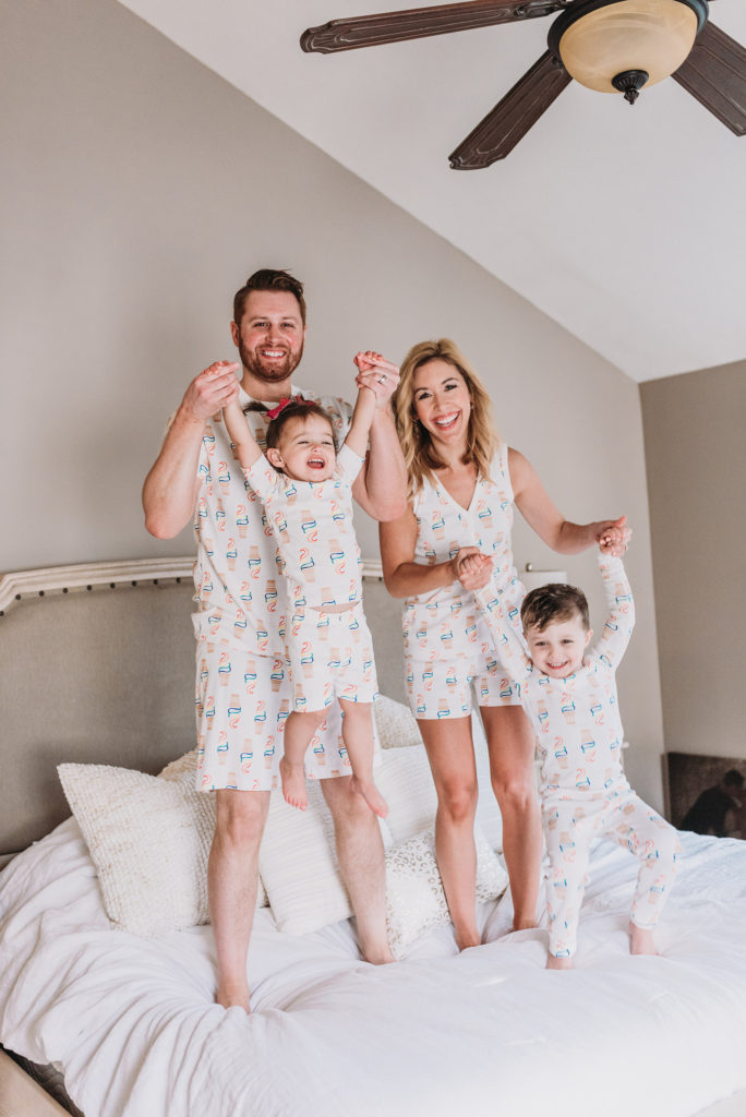 YouTube Moms Brianna K with husband Adam son Landon and daughter Presley jumping on bed in white pajamas with rainbow ice cream cones from Hanna Andersson| 10 SUMMER MUST HAVES 2019 BITS OF BRI BLOG BY BRIANNA K