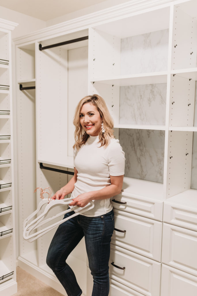 Brianna K in master closet with white built ins from Home Depot Closetmaid and white marble contact paper with white velvet hangers with rose gold hooks. Extreme konmari tips to declutter your closet from Brianna K youtube bitsofbri blog 