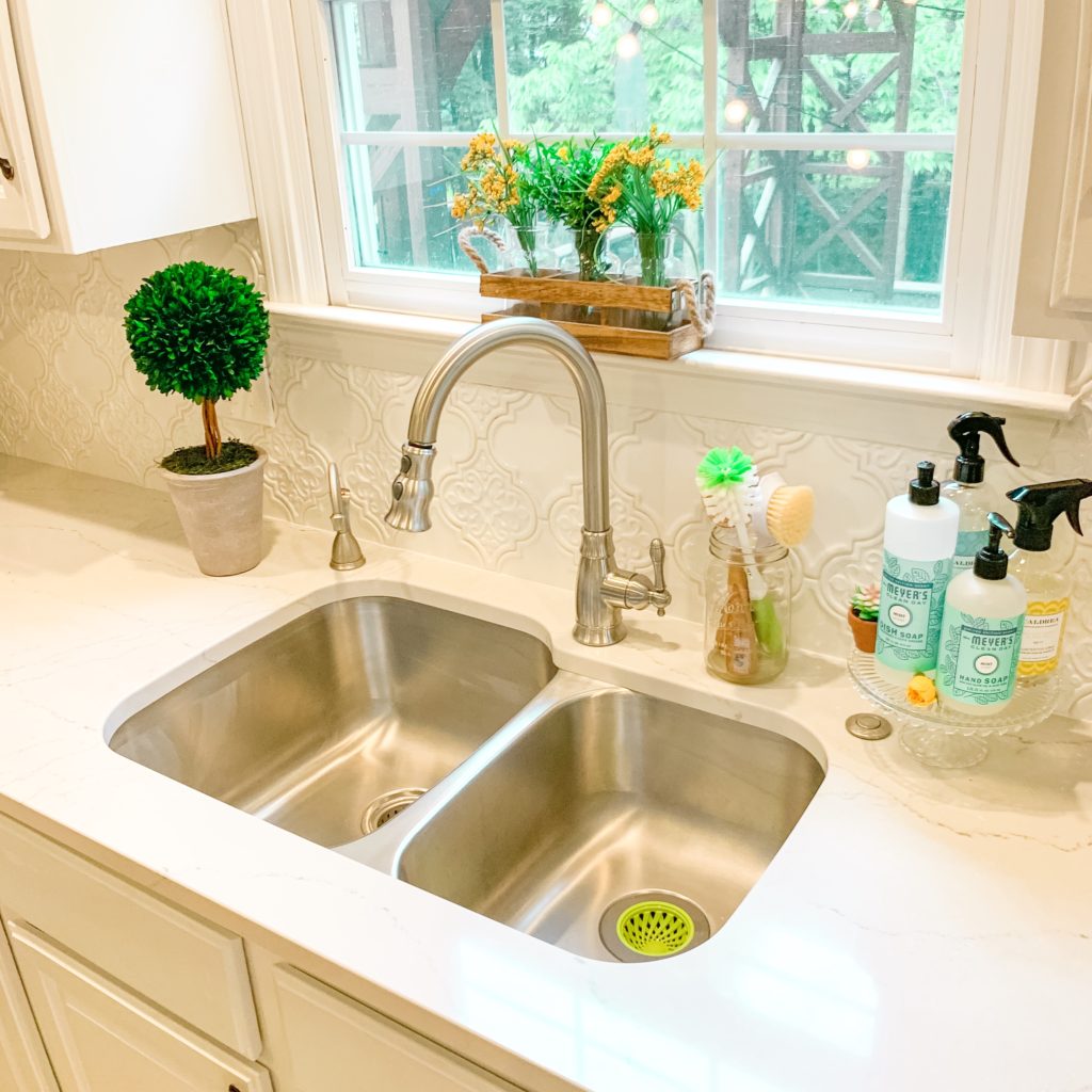 Sparkling clean kitchen sink after deep clean Brianna K new kitchen sink and countertops and backsplash tile - white marble Cambria quartz Ella countertops with white arabesque Tile from Home Depot with stainless steel 60/40 kitchen sink and cleaning products from Grove Collaborative for how to deep clean your kitchen sink post on bitsofbri blog 