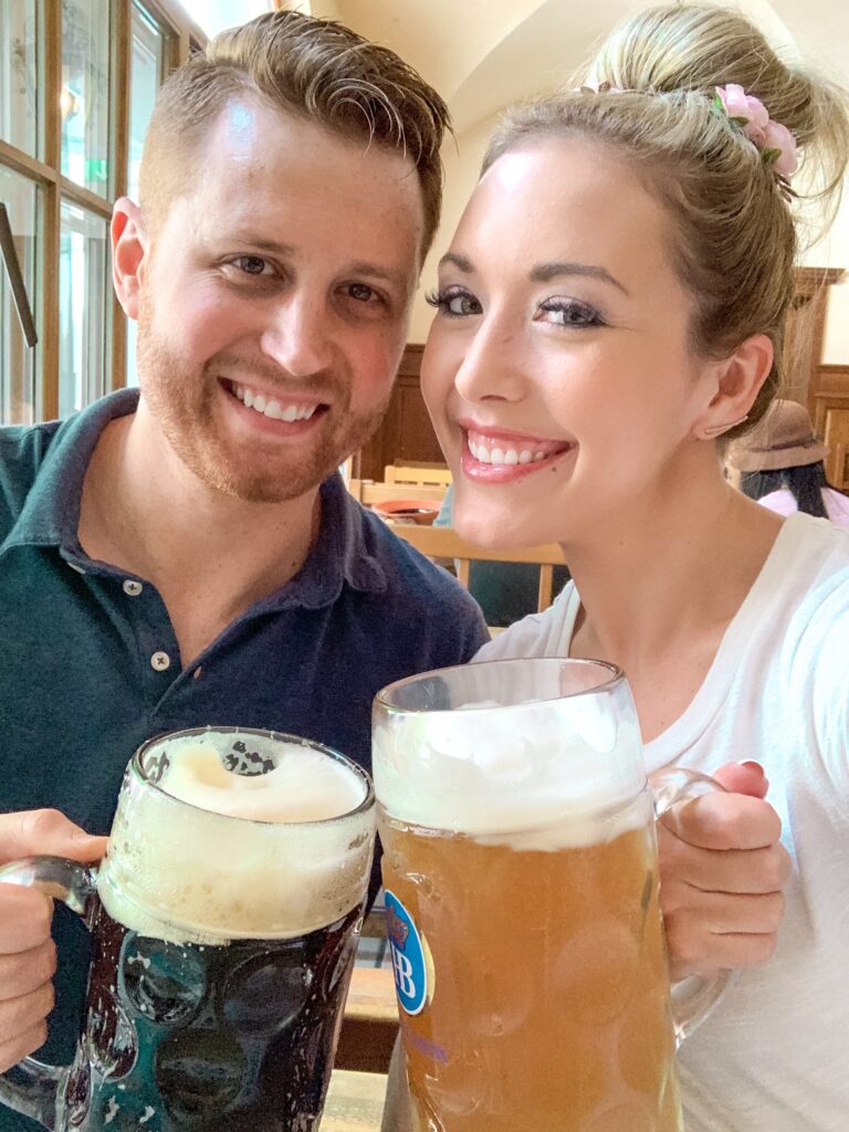 Adam and Brianna K cheers Prost with beer steins at the original Hofbrauhaus in Munich Germany Oktoberfest MUNICH, GERMANY TRAVEL DIARY | 4-DAY ITINERARY AND TRAVEL TIPS Brianna K bitsofbri young family traveling the world 