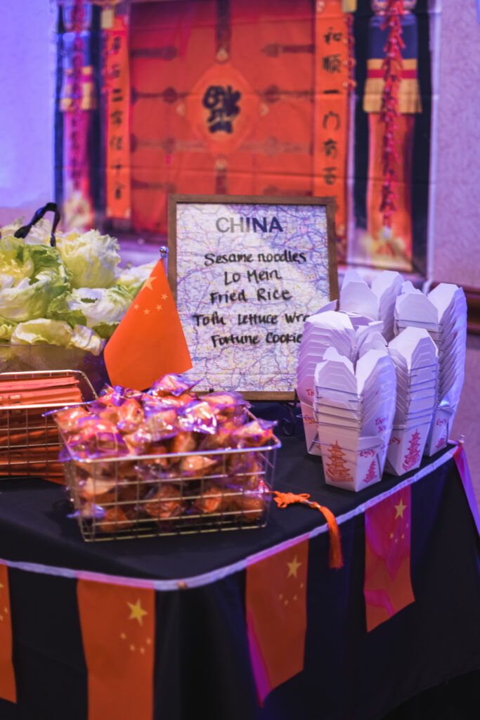 Chinese food station and Saturday night reception globe and suitcase  centerpieces with luggage tag party favors travel theme party decor decorations for a travel themed around the world bar mitzvah celebration Brianna K bits of Bri party planner 