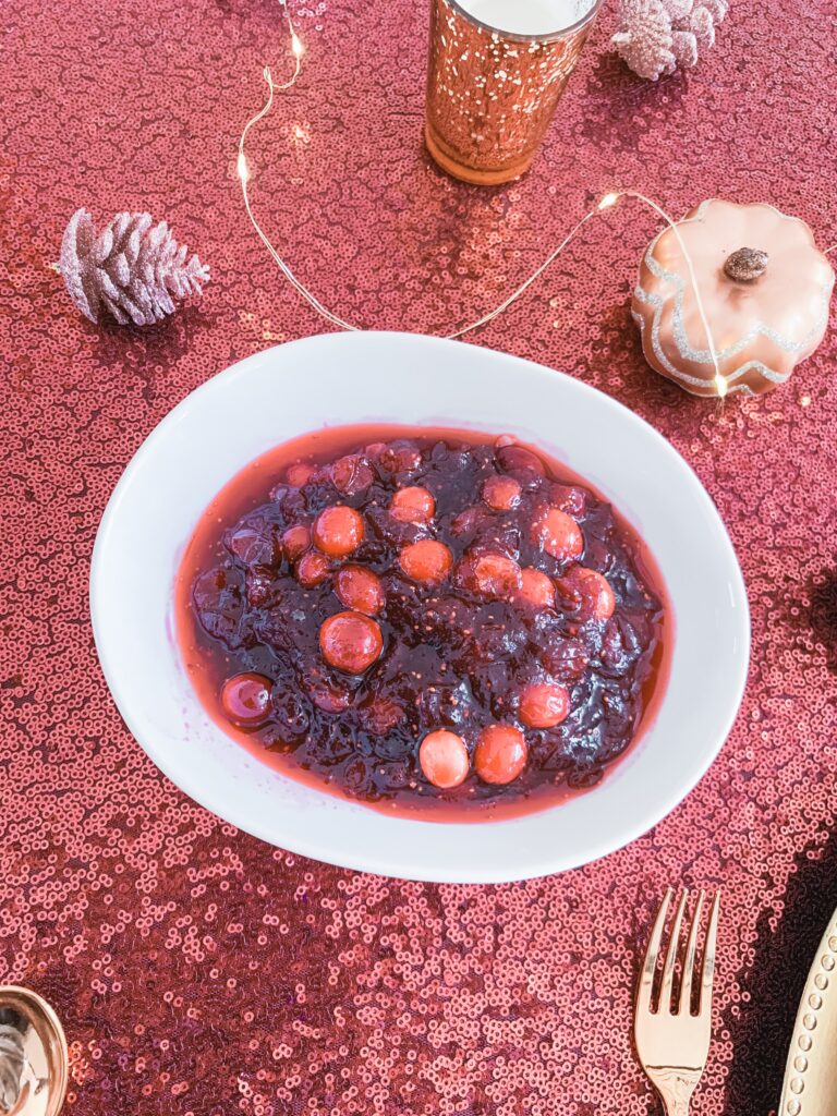 simple cranberry sauce in round white bowl with glitter table cloth and thanksgiving decor THE BEST THANKSGIVING RECIPES | EASY + DELICIOUS BRIANNA K bitsofbri