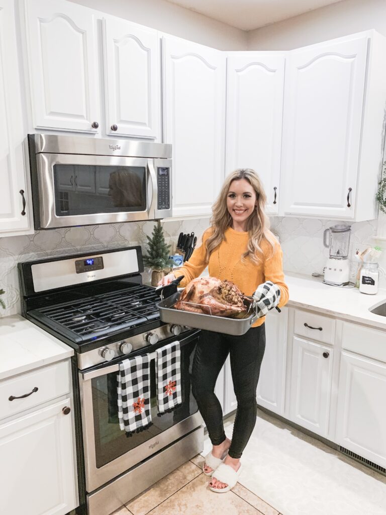 woman holding turkey in roasting pan THE BEST THANKSGIVING RECIPES | EASY + DELICIOUS BRIANNA K bitsofbri